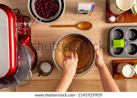 Hand mixing ingredients needed for muffin dough