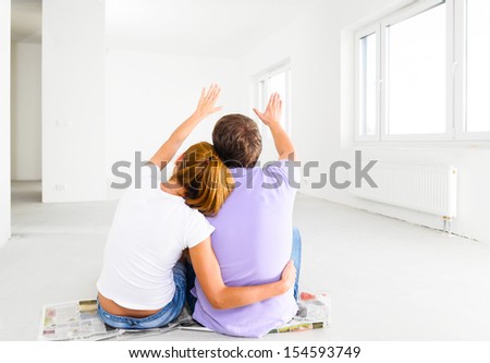couple at their new empty apartment Royalty-Free Stock Photo #154593749