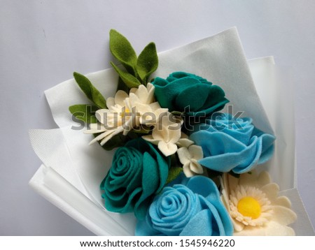 Beautiful, lovely, and cute handmade Tosca Cream Blue felt flower bouquet for event, wedding, gift, spring, valentine, celebrations, or postcard and stamp picture. Romantic flowers and Leafs. Greenery