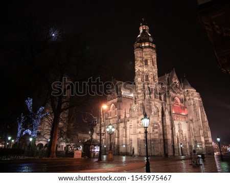 Rainy Christmas night in Kosice. Beautiful view on Dom sv. Alžbety (St. Elisabeth church) at night. Beautiful lights on trees around park. 