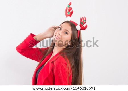 Festive Christmas portrait of a young,Portrait of beautiful happy woman wearing Christmas reindeer antlers headband,happy funny and smiling,posing and looking at the camera on white background.