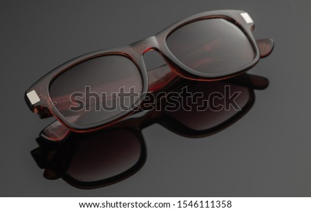 summer glasses with reflection on a dark background