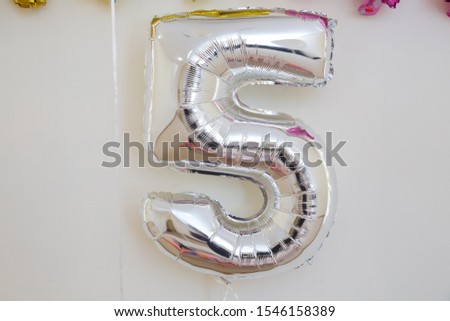 One of full number set .Chrome number 5 made of inflatable balloon isolated on white background. One of full number set . White number five 5 made of helium balloon isolated on white background.