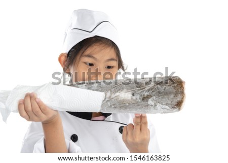 Surprising chef in uniform holding big freezing fish on white background.