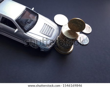 car model and coins on a black background