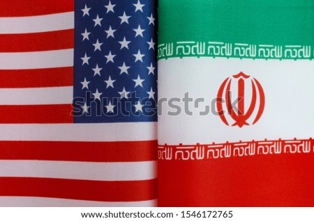 fragments of the national flags of the United States and Iran close-up concept