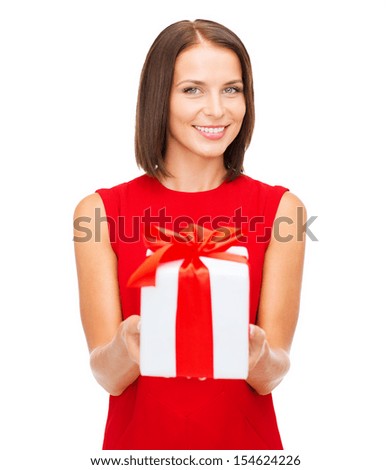 christmas, x-mas, valentine's day, celebration concept - smiling woman in red dress with gift box