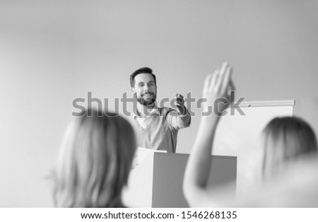 Black and white photo of businessman asking colleagues opinion