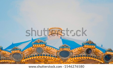 Beautiful bright roof carousel with blue sky, Carnival background