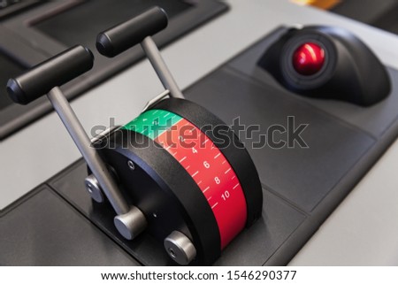 Modern ship control panel with engine accelerator and red trackball Royalty-Free Stock Photo #1546290377