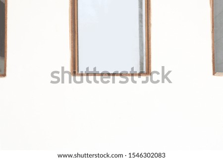 wooden frame with glass on the white wall 