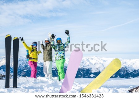 Photo of three athletes standing in ski resort.