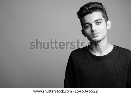 Portrait of young Indian man in black and white