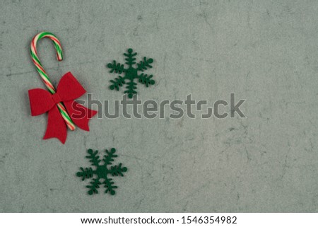 candy canes, colorful cane candy on green background decorated for new year with copy space. traditional noel sweet. top view of Christmas candies
