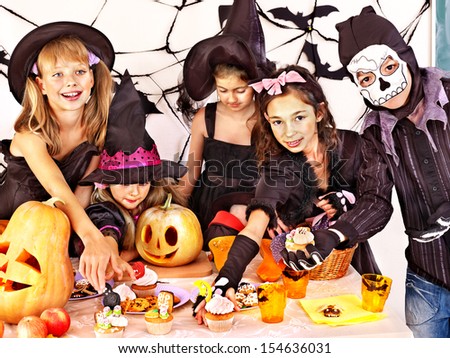 Halloween party with children holding carving pumpkin