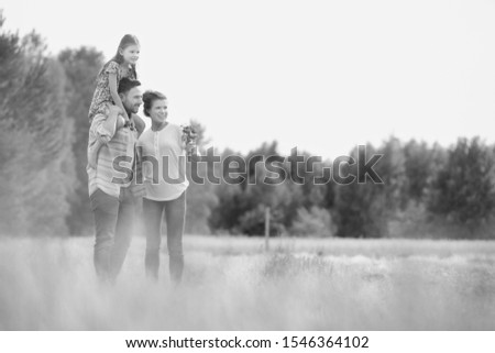Black and white photo of Happy family walking in wheat field