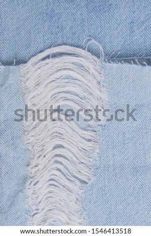 Close up bue Jeans or or hole and threads
