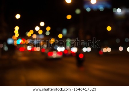 Colorful bokeh and blur light of cars stop on the road during rush hour and traffic jam in the dark city night.