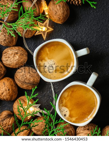 coffee, New Year, Christmas background or Noel holiday festive (nuts, specials, decorations and gifts on the table, greeting card) menu concept. food background. copy space. Top view
