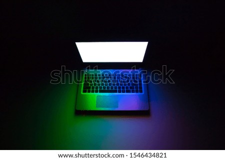Colorful laptop isolated on black background