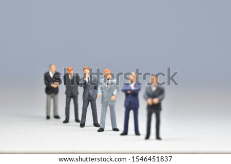 Miniature people business men are standing in line
