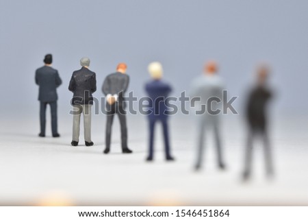Miniature people business men are standing in line