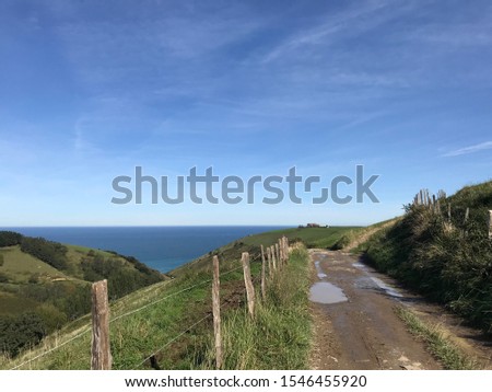 Sandy road treck on the mountains with the sea ocean water surface view on horizon 