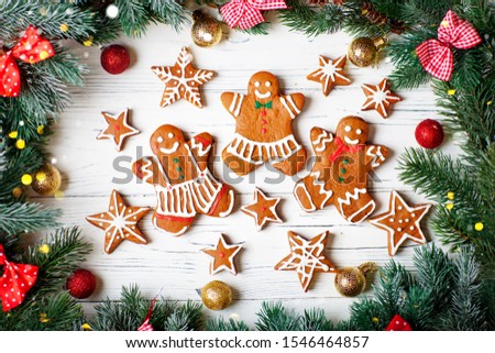 Handmade festive gingerbread cookies in the form of stars, snowflakes, people for Christmas and new year holiday on a white wooden table.