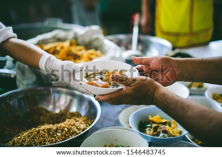 The concept of food needs, food shortages: free food distribution to the poor, food aid in human society Royalty-Free Stock Photo #1546483745