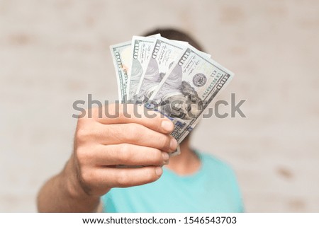 Man's hands holding hundred dollar bills. Business concept