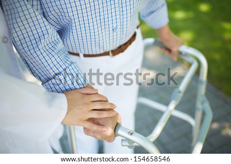 Close-up of clinician hand on that of disabled woman Royalty-Free Stock Photo #154658546