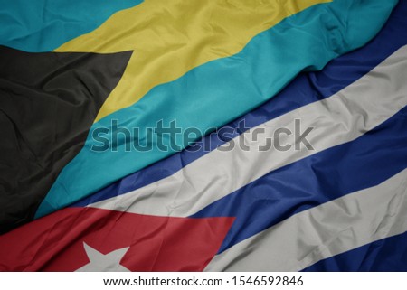 waving colorful flag of cuba and national flag of bahamas. macro