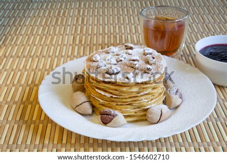 Pumpkin pancakes with pecans and currant jam