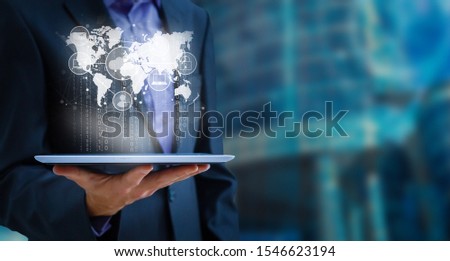 Businessman using tablet analyzing sales data and economic growth graph chart, Technology and icon customer global network connection. Business strategy. Innovative. Digital marketing