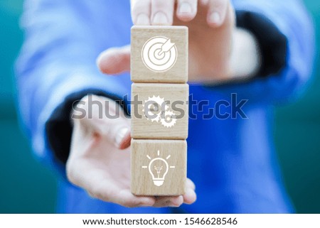 Man hand arranging wood block with icon goal strategy and action business plan.