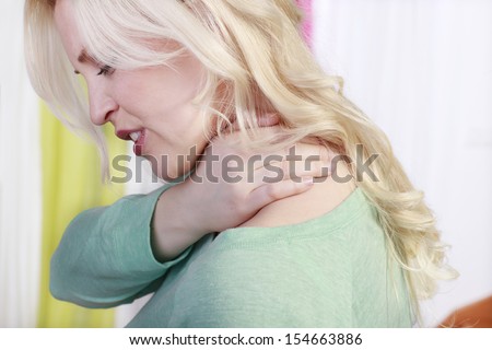 Woman with shoulder pain Royalty-Free Stock Photo #154663886