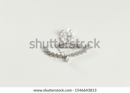 Accessories for the bride. Imitation Jewelry - polished silver necklace on white background.Place for text, advertising.