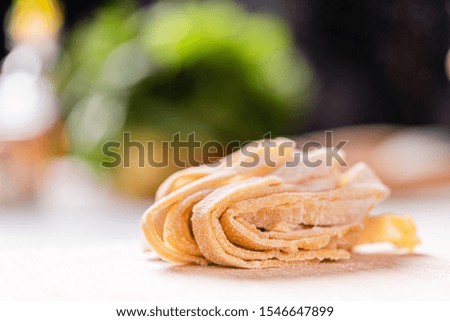 
Freshly made Italian pasta rolled into a nest. Close-up.