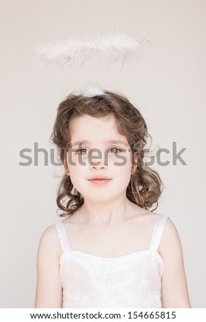 A little girl enjoying her angel halo and outfit at Christmas