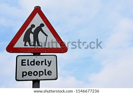 UK warning road sign Elderly people. Frail or disabled pedestrians likely to cross road ahead