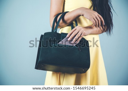 woman hand phone with bag in studio