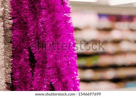 Festive Christmas decoration of colorful tinsel for the Christmas tree and house.