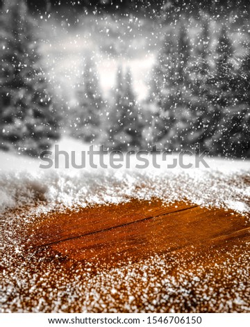 Wooden desk of snow and frost and free space for your decoration. Winter landscape of forest with fir branches. Christmas time. 