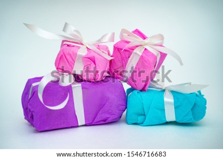 Gifts in packing on a white background. Holiday concept. Gentle colors.