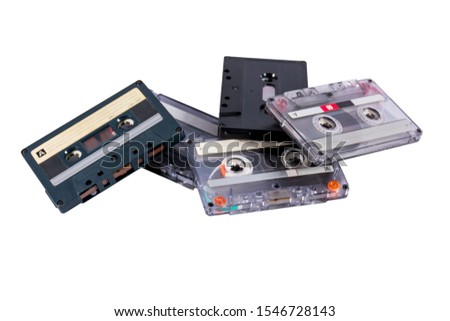 Old cassette tapes in a heap isolated on white background