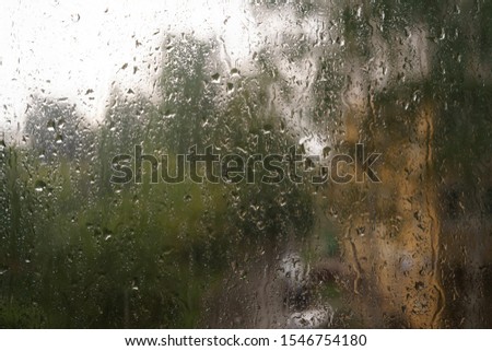 heavy rain drops on window. water on glass. background