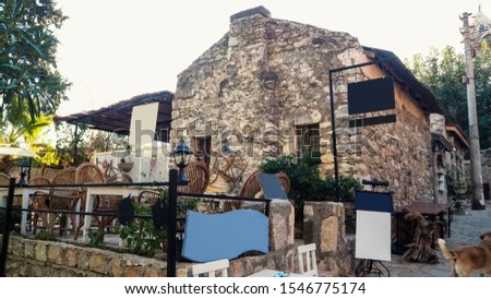 Old Datca houses. Houses made of stone. Streets decorated with pink and white bougainvillea. The town of Datca in Turkey