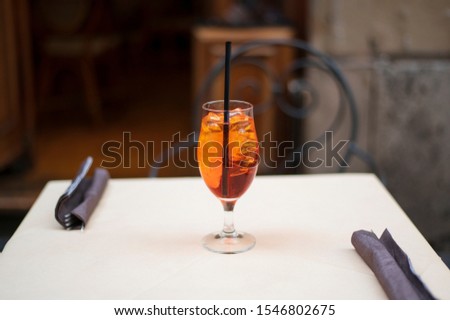Glass of Aperol Spritz cocktail on the table in a terrace of restaurant