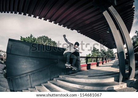 Skateboarder jumping stairs in the street. 