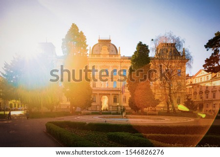 University of Maribor building in classic style with background. Modern education concept. Street architecture and cityscape. Elementary student. House facade. Architectural design. Fun flare.